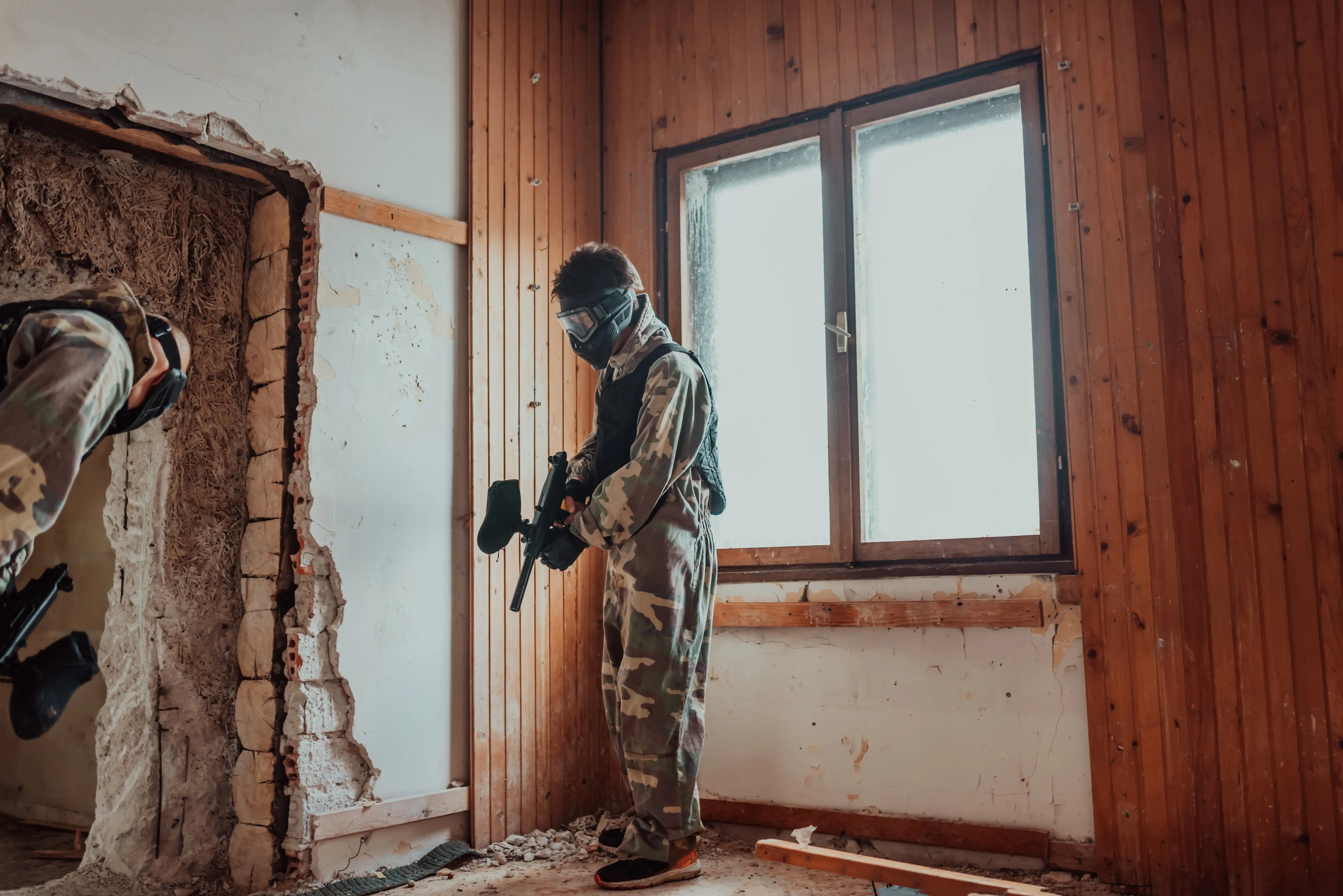 Photograph of a paintball team in action with professional gear, captured with selective focus.