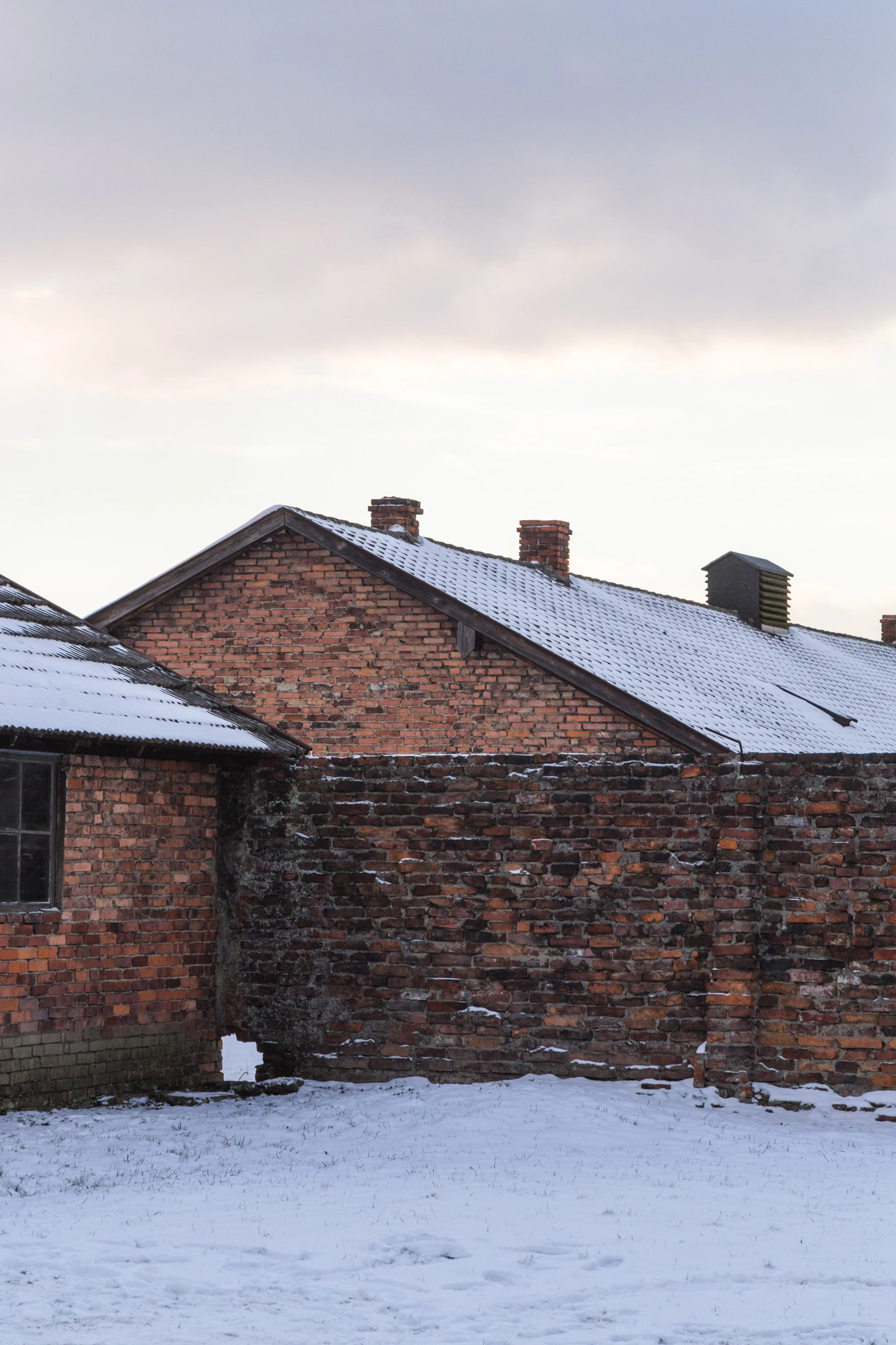 A house on a snow-covered field against the sky